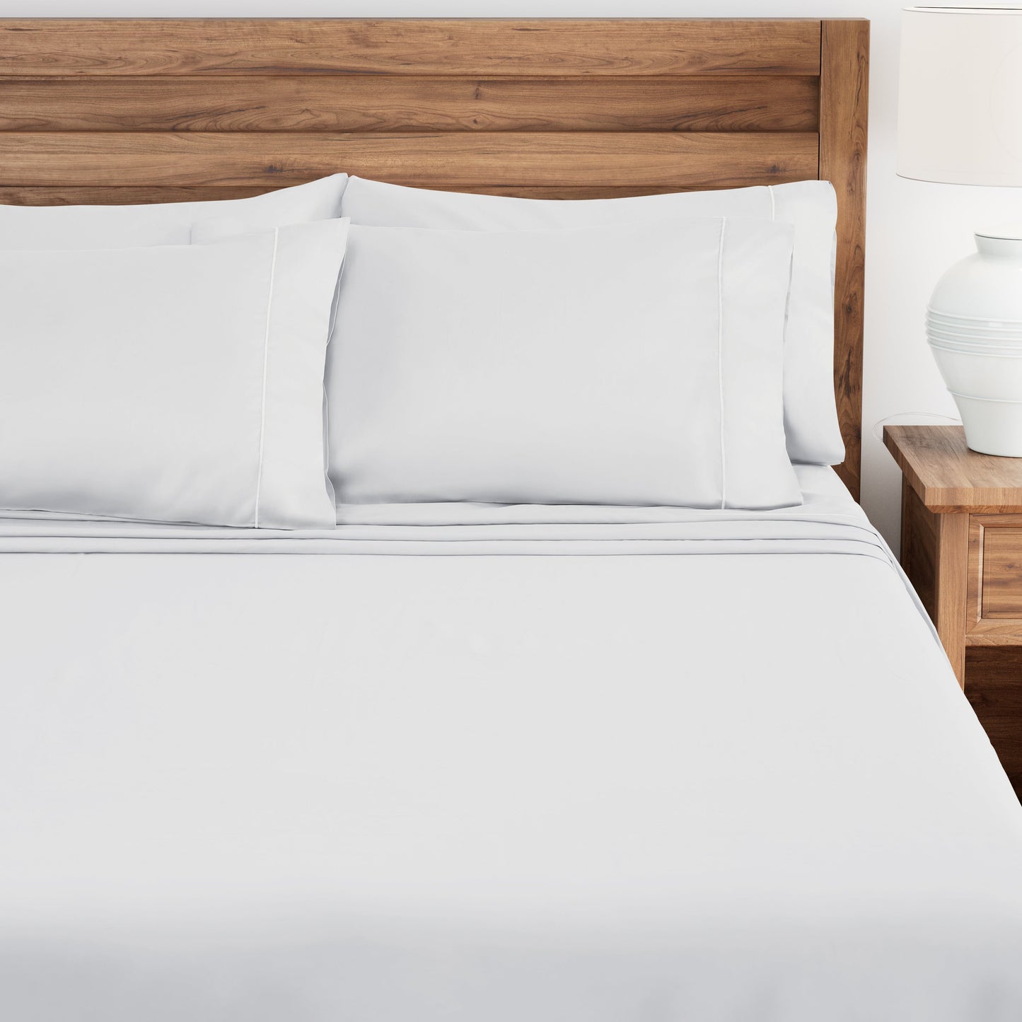 Bed with white bedding and wooden headboard