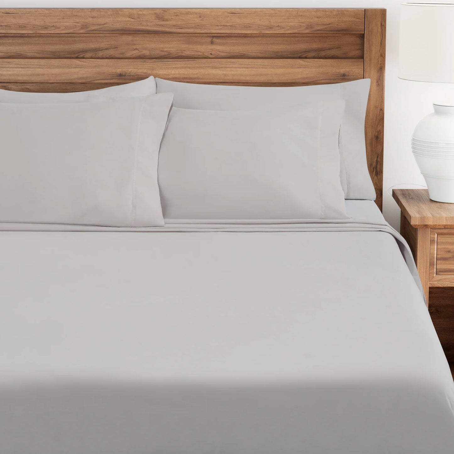 Lunar Rock bedding set on a bed with wooden headboard and nightstand.